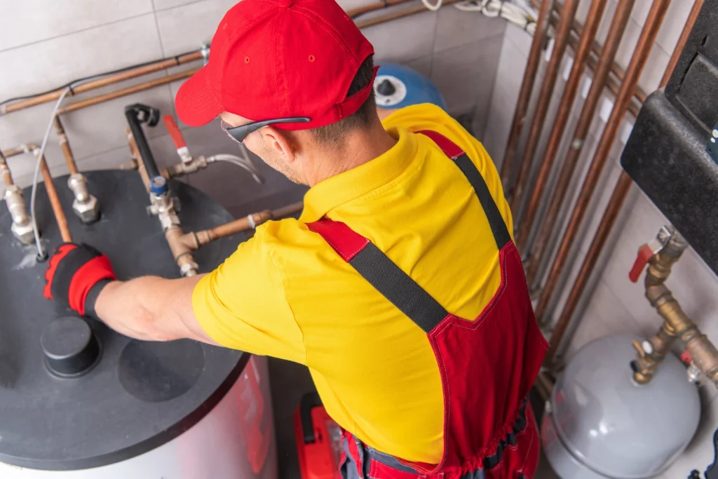 Technician servicing a residential water heater in Dade City, FL